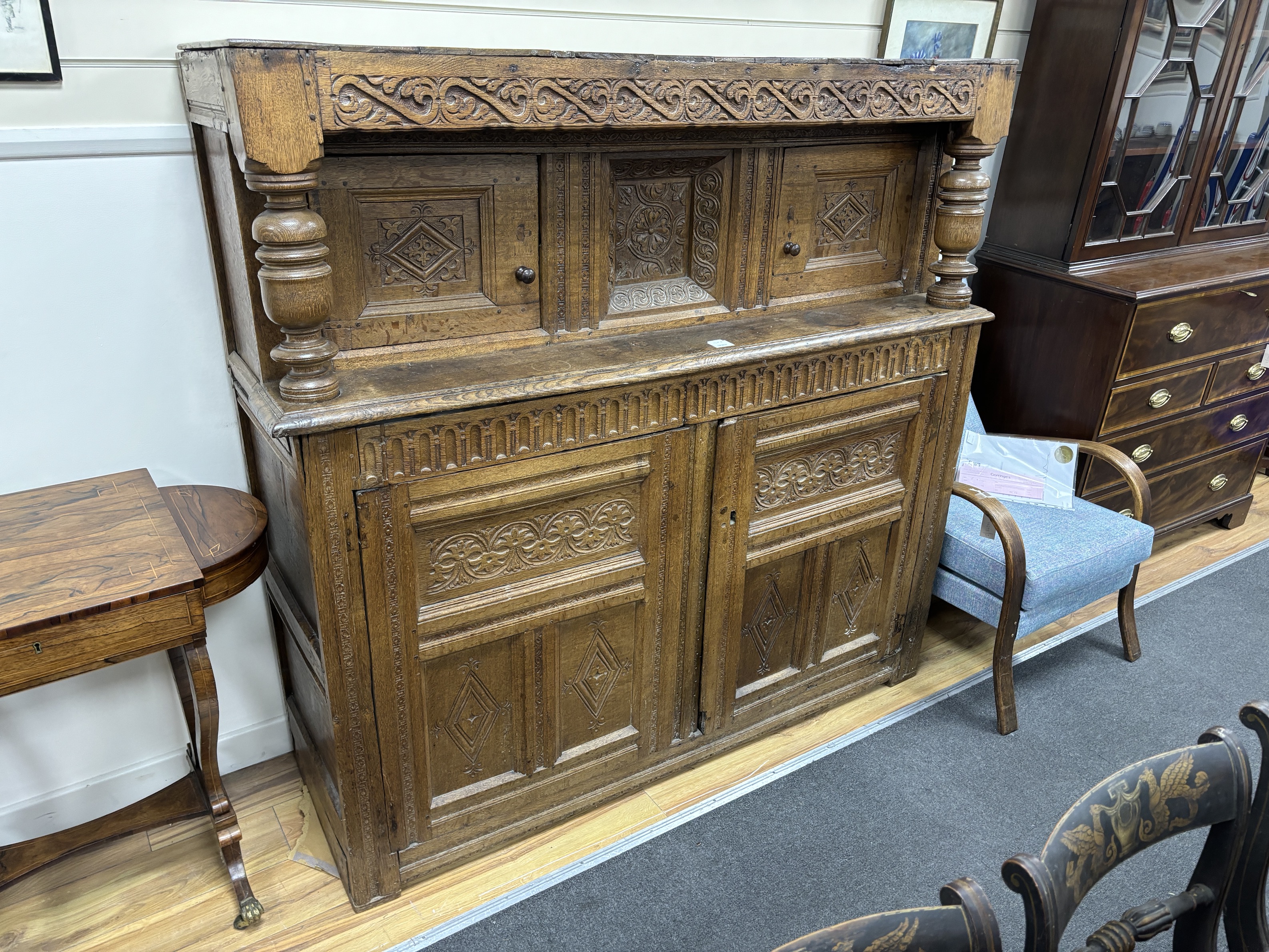 A late 17th century Yorkshire oak court cupboard, width 146cm, depth 50cm, height 146cm, Provenance- Brede Place, East Sussex, a former residence of the Frewen family from 1712-1936.